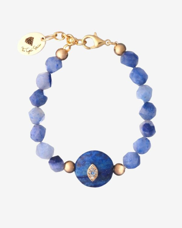 Light blue faceted Quartz bead bracelet featuring a central dark blue stone with a gold and crystal evil eye element.