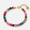 Colorful handmade bracelet featuring faceted Agate gemstones in red, blue, and green with gold-plated hardware.