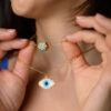 Close-up of model showcasing Miyuki beaded necklaces with eye designs made with Peyote stitch by The Gem Stories.