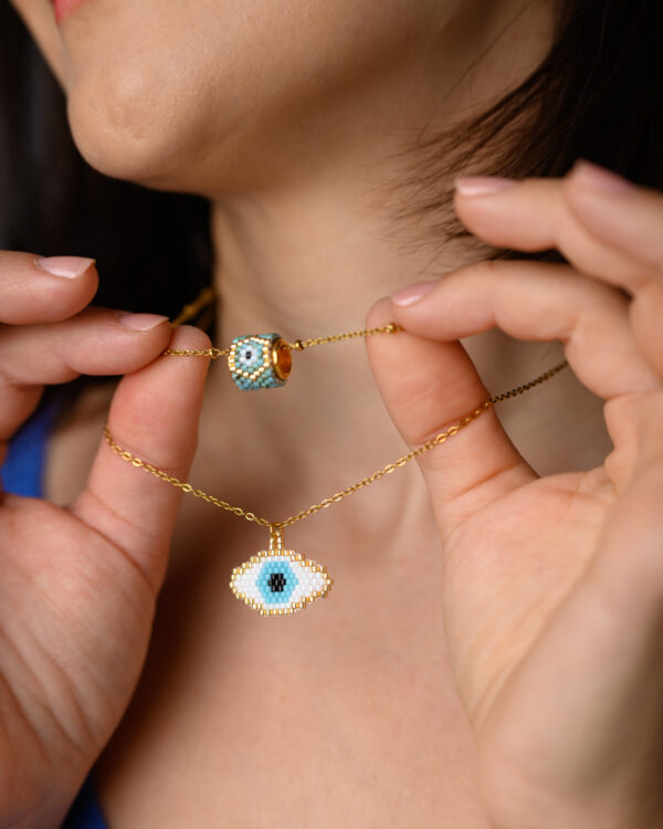 Close-up of model showcasing Miyuki beaded necklaces with eye designs made with Peyote stitch by The Gem Stories.