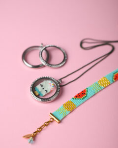 Miyuki Memory Locket with ice cream design and loom-stitched bracelet by The Gem Stories on a pink background.