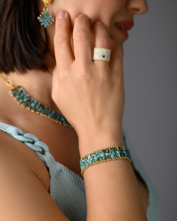 Miyuki hand-stitched ring, Tila necklace, and bracelet by The Gem Stories, featuring intricate beadwork in turquoise and white.