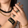 Model showcasing black and gold Miyuki Peyote-stitched rings and a loom-stitched bracelet by The Gem Stories.