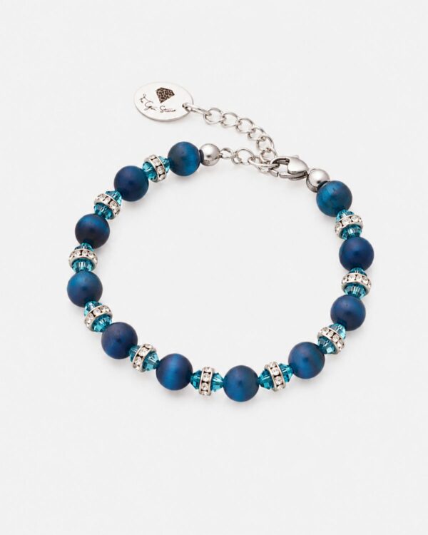 Natural blue tiger eye bead bracelet from QZ384718-The-Gem-Stories-Blue-Tiger-Eye-Allover-Bracelet.jpg, featuring deep blue chatoyant stones, turquoise-colored crystal bicones, and silver-toned crystal rondelles with rhodium-plated hardware on a white background.