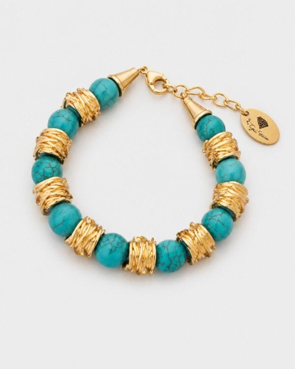 Handmade turquoise howlite bracelet with gold-plated twisted spacers and heart clasp by The Gem Stories