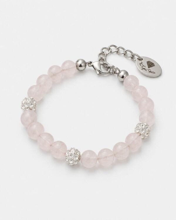 Pale pink rose quartz bead bracelet featuring three shimmering Preciosa crystal pavé balls and polished rhodium-plated hardware, as seen in 6KTK5639-The-Gem-Stories-Roze-Quartz-Bracelet-with-Preciosa-Crystal-Balls-Rhodium.jpg, displayed on a clean white background with a signature logo tag.