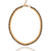 Miyuki Side Tila necklace with black and gold beads in an intricate woven design.
