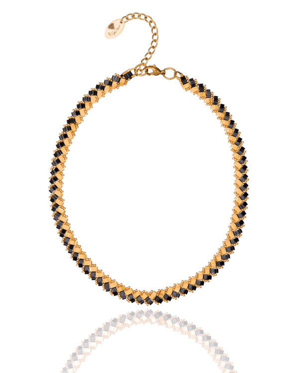 Miyuki Side Tila necklace with black and gold beads in an intricate woven design.