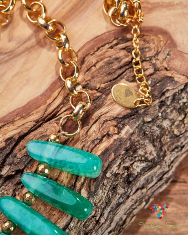 Green agate sticks and chain necklace displayed