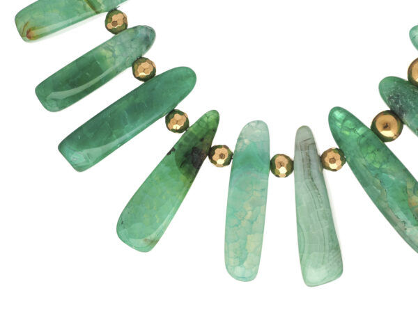 Green agate sticks necklace jewelry displayed
