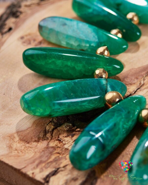 Green agate sticks necklace with gold details displayed