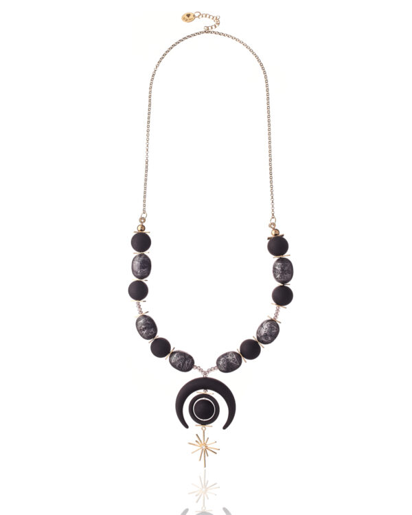 Delicate Moonstar Necklace with crescent moon and star pendant on a silky background.