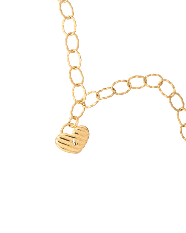 Close-up of a gold heart necklace with a textured heart pendant on a delicate chain.