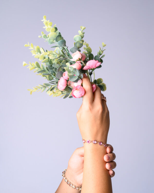 Close-up of a Rose Rivoli Bracelet with pink gemstones on a woman's wrist