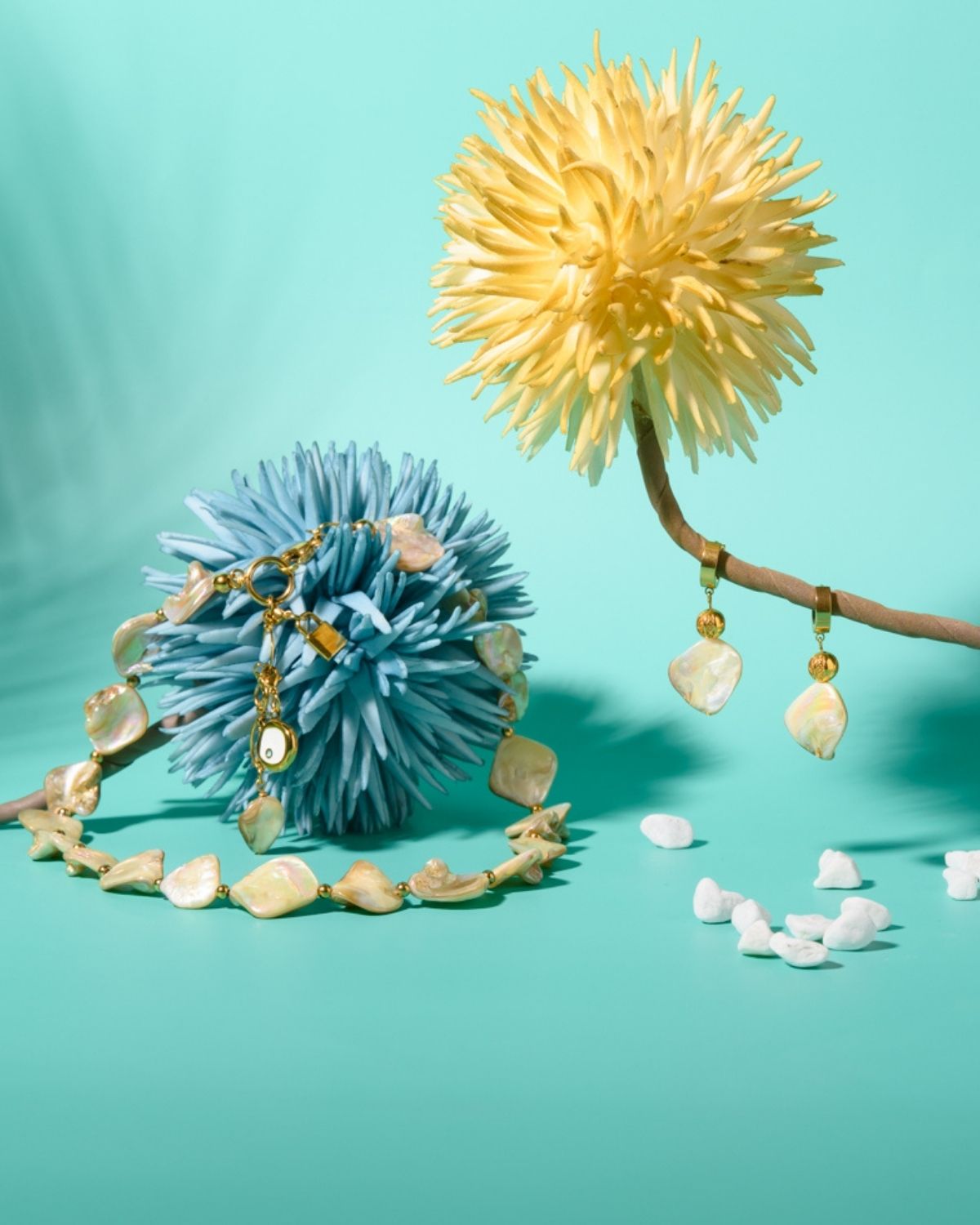 Elegant jewelry set featuring a necklace and earrings with delicate white beads and gold accents