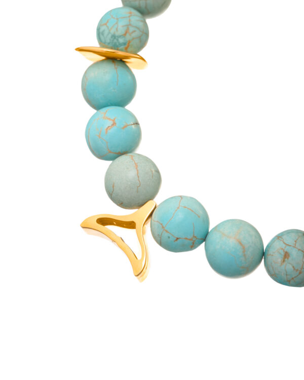 Elegant turquoise necklace with mixed elements on a golden chain