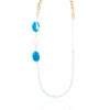 Pale blue jade necklace with agate stones and gold chain on a white background