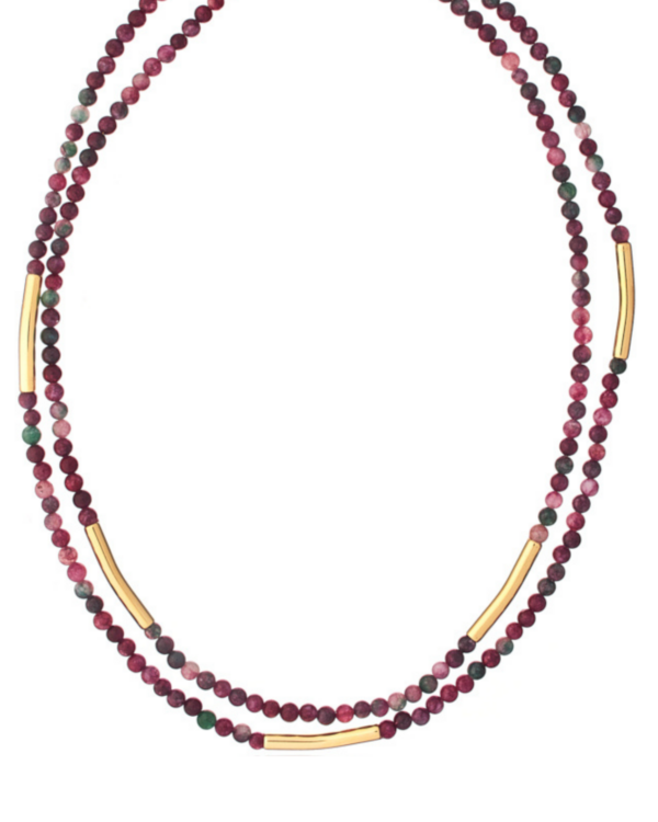 Woman wearing a double-strand necklace with red agate beads and gold accents