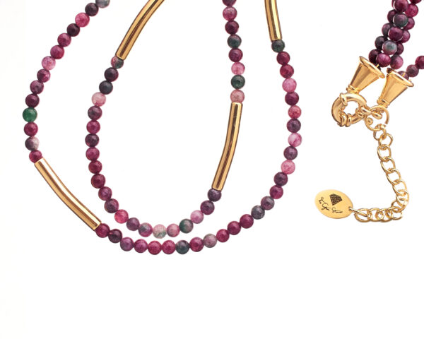 Close-up of a double-strand necklace with red agate beads and gold accents