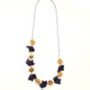 Colorful acrylic element necklace displayed on a minimalist white background.