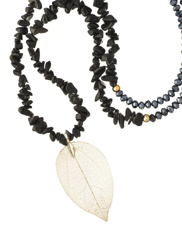 Black necklace with leaf detail displayed