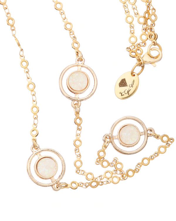 Long gold necklace with diamond-studded round pendants.