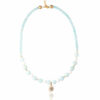 Elegant necklace with pastel blue jade, coral accents, and a protective eye charm.