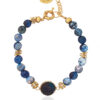 Blue agate bracelet with gemstone element and gold accents on a white background