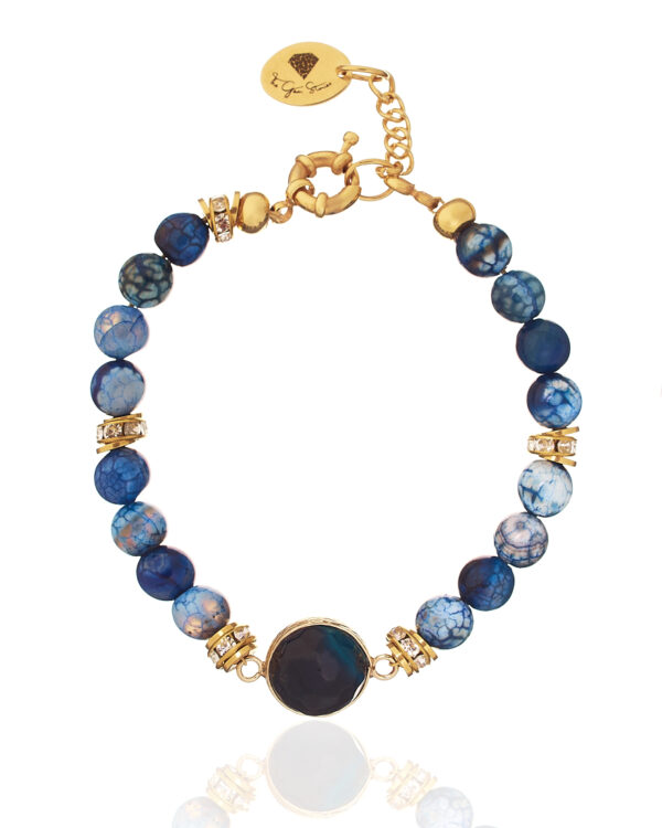 Blue agate bracelet with gemstone element and gold accents on a white background