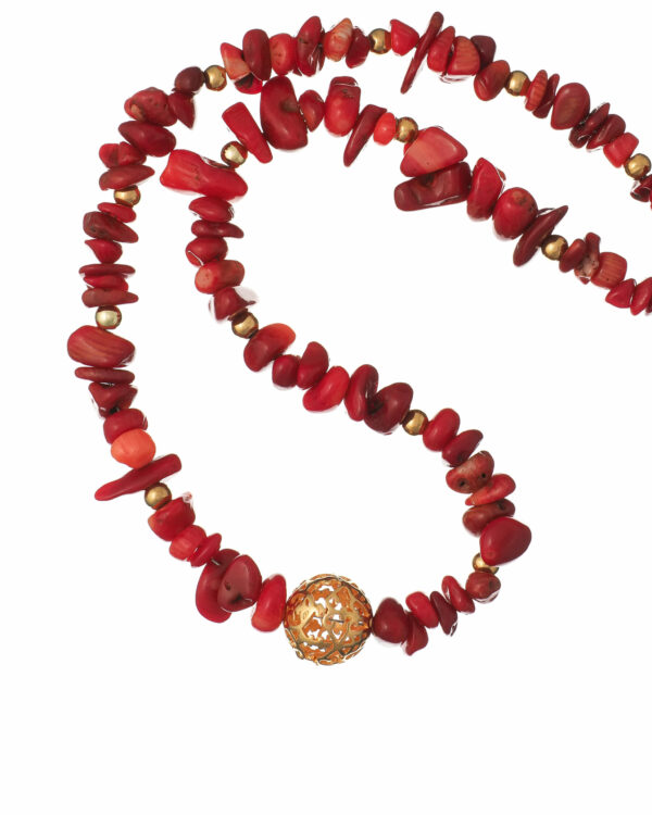 Elegant necklace with small red coral chips and a silver filigree centerpiece.