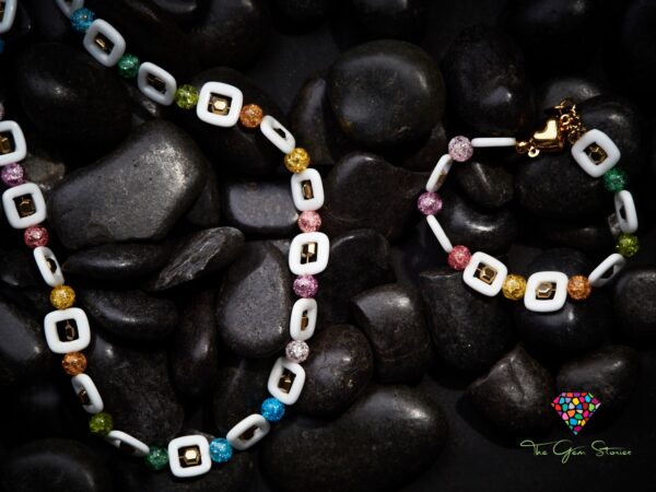 Colorful crackle crystals and square agate necklace and bracelet set on black stones background with a heart-shaped clasp