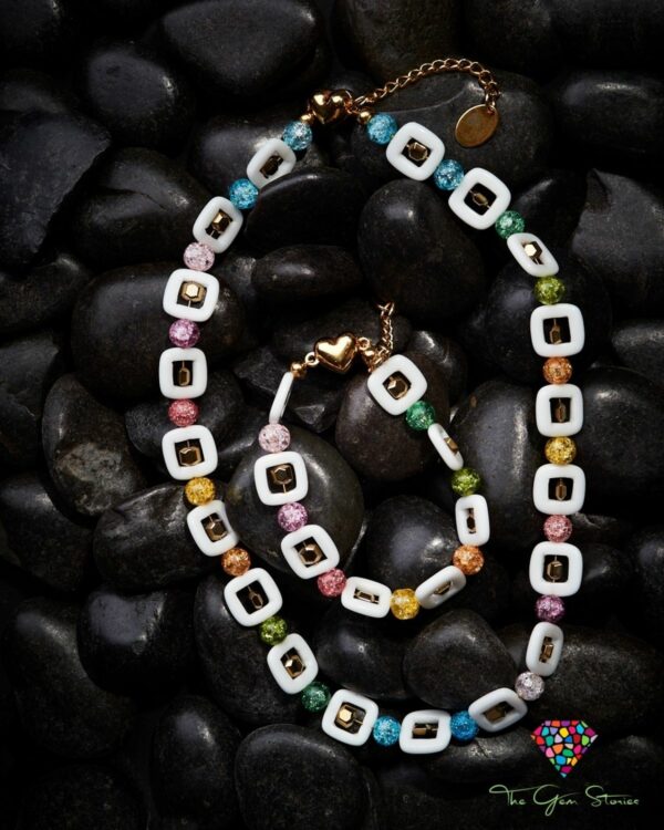 Colorful crackle crystals and square agate necklace and bracelet set on black stones background