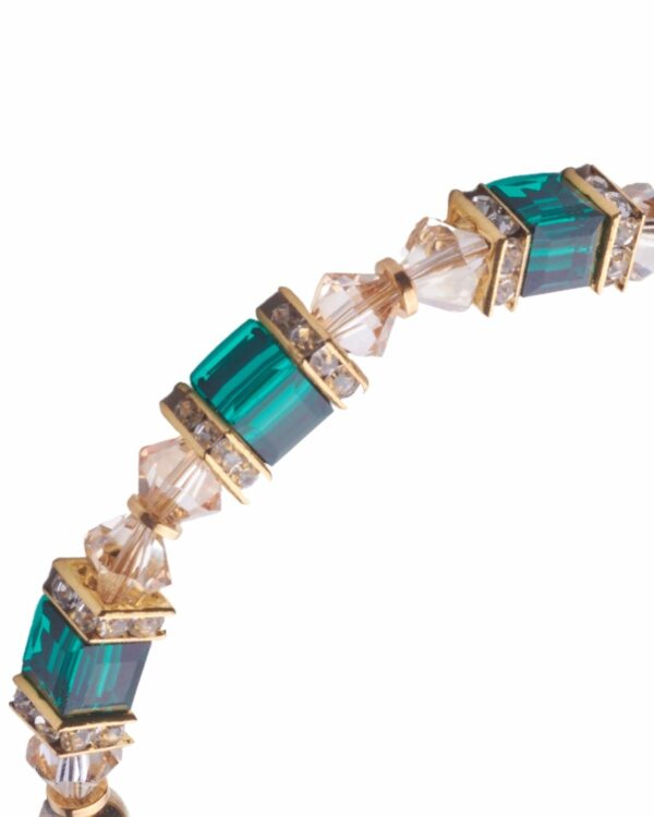 Close-up of emerald minimal bracelet with green and clear crystal beads and gold accents