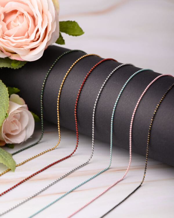 Collection of long chain necklaces with colorful dotted designs