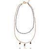 Rosario necklace with shimmering drop elements against a dark background.