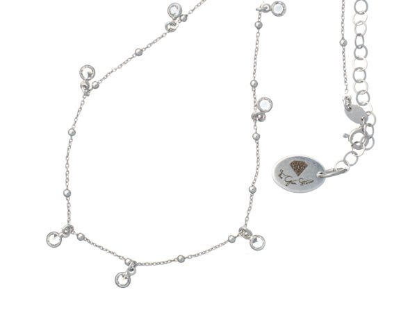 Necklace with white drop pendants and rhodium plated chain.