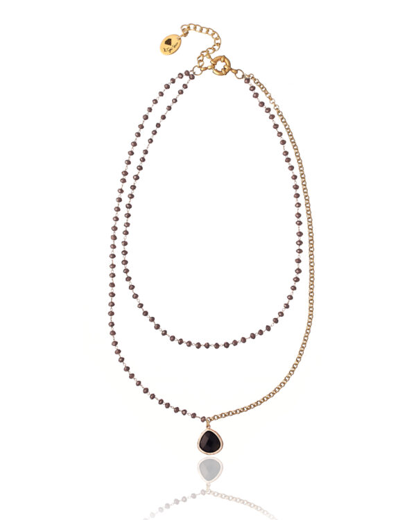 Elegant Rosario necklace with a single crystal element on a light background.