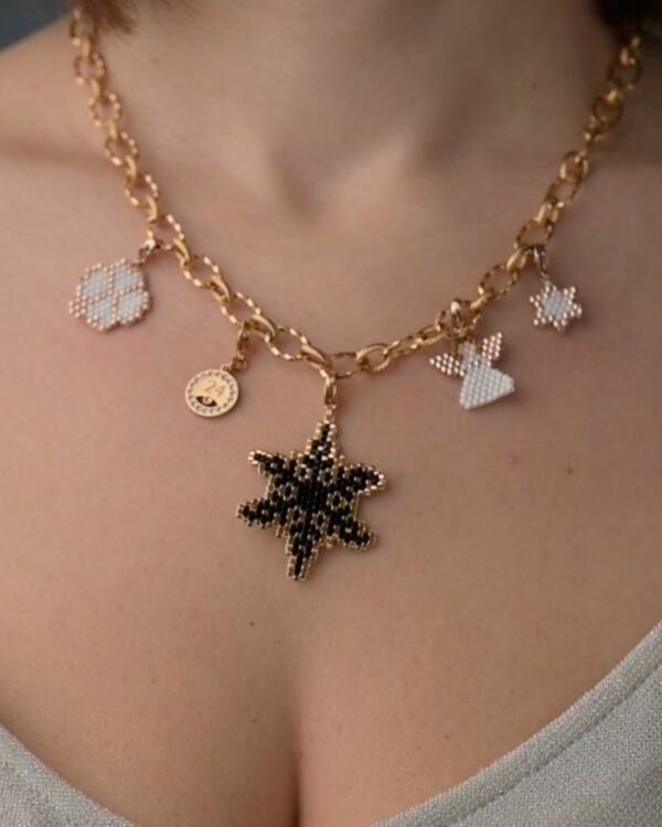 Close-up of intertwined silver aesthetic necklace chain.