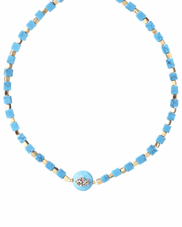 Turquoise cubes necklace with gold elements and a central fish pendant on a white background