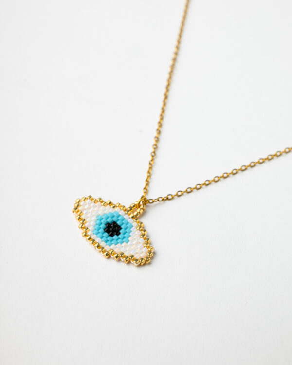 Elegant gold chain necklace with a Miyuki beadwork oval eye pendant from The Gem Stories.
