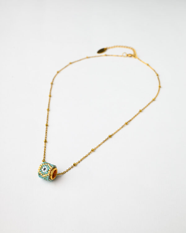 Elegant gold chain necklace with a Miyuki beadwork round reel pendant from The Gem Stories.