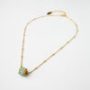 Elegant gold chain necklace with a Miyuki beadwork round reel pendant from The Gem Stories.