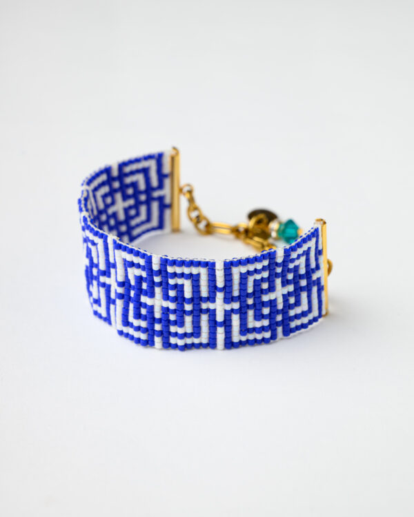 Close-up of Miyuki Aegean Maze Loom Bracelet with gold clasp and blue and white design