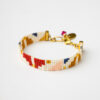 Handmade Miyuki Loom Seraphina Bracelet with gold clasp and multicolored beadwork, featuring a pink crystal charm.