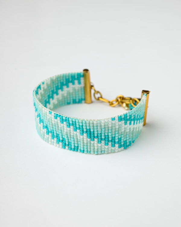 Miyuki Loom Jewelry Bracelet with a turquoise and white zigzag pattern, featuring a gold clasp and chain links.