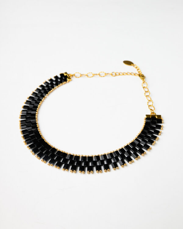 Elegant black Miyuki Tila bead necklace with gold accents by The Gem Stories.