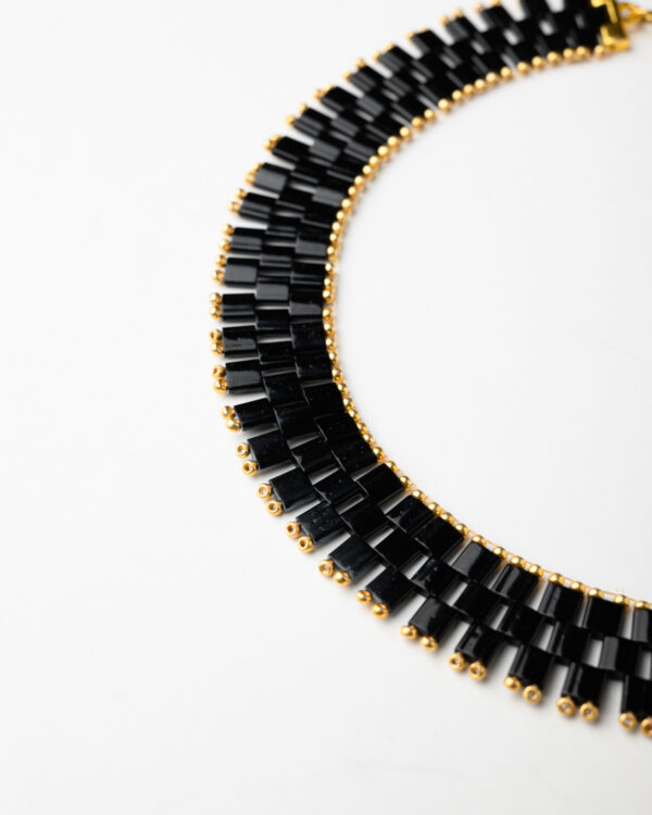 Chic black Miyuki Tila bead necklace with gold detailing from The Gem Stories.