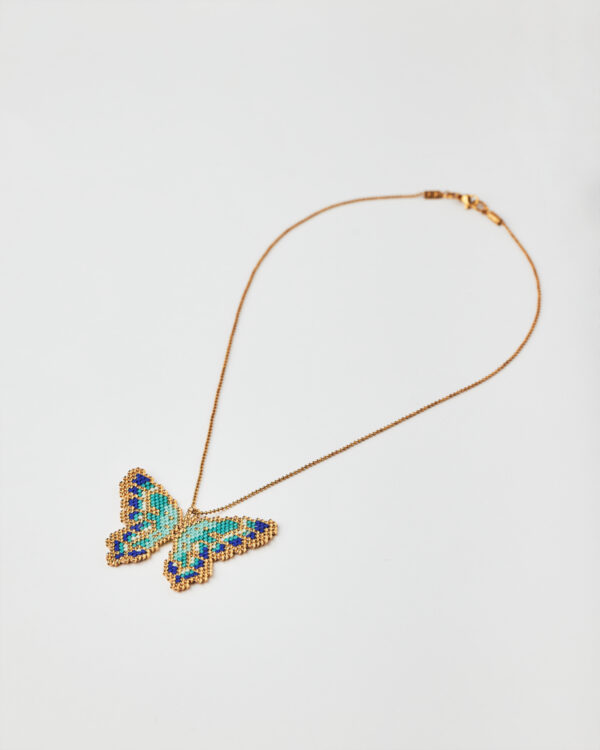 Intricate Miyuki bead butterfly necklace in shades of turquoise, blue, and gold.