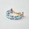 Handmade Miyuki loom-stitched bracelet with blue, green, white, and gold mosaic design.