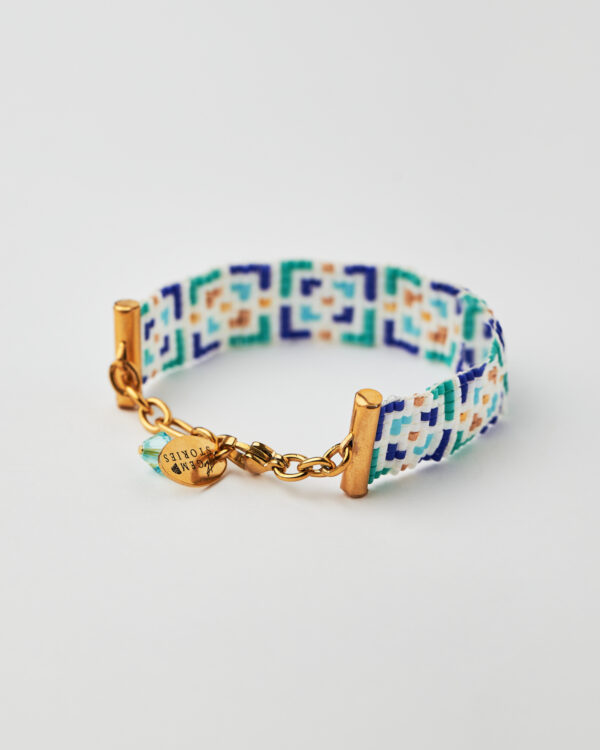 Intricate loom-stitched bracelet with Miyuki beads in blue, green, white, and gold mosaic design.